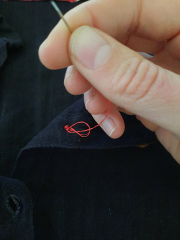 Knotting a loose stitch to secure thread