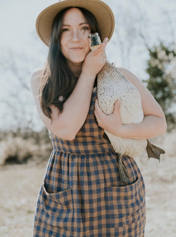 Karmen wearing a Pyne & Smith linen pinafore dress