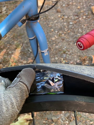 Booting a tire with a nutrition wrapper. 
