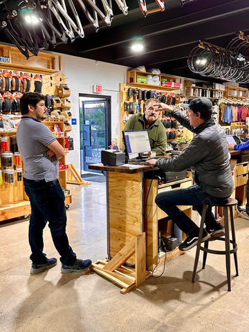 man helping customer in a bike shop