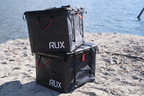 2 RUX 70L, one on top of the other, close up shot on the beach.