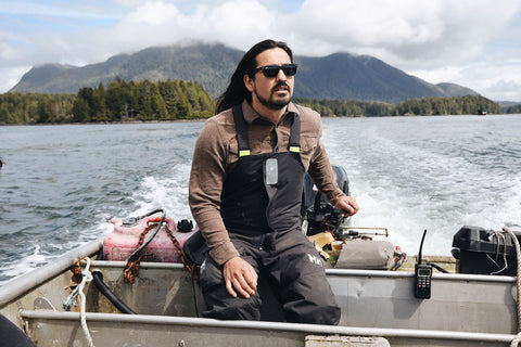 Steve Dennis piloting a skiff through the picturesque Tofino coast.