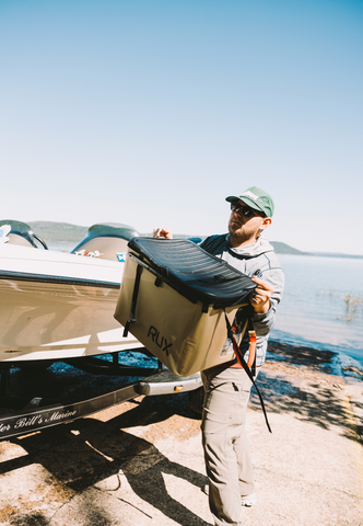 Man carrying all his fishing gear using the RUX 70L