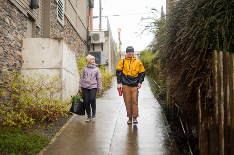 Two friends walking on campus with their RUX tote keeping their campus gear dry.