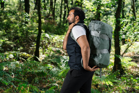 Man carrying on his back The North Face Base Camp Voyager while hiking.