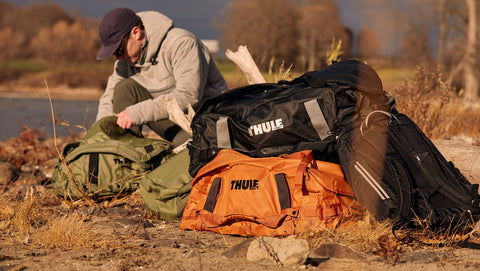 Man getting his gear out of the Thule Chasm 70L