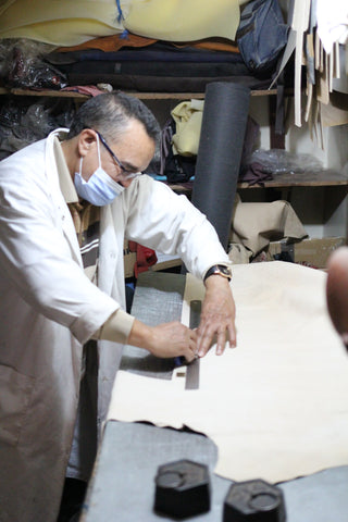 Abdou planning cuts on a hide in the small upstairs workroom