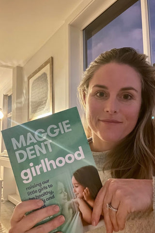 Kate holding Maggie Dent book girlhood