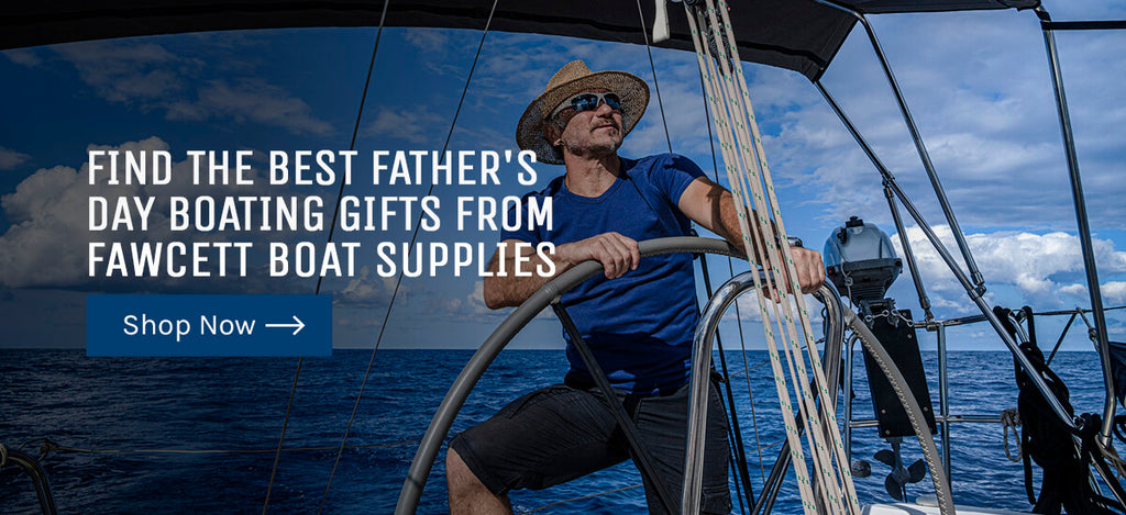 An image of a dad at the helm of a sailboat wearing sunglasses and a straw hat that says "Find the best Father's Day Boating Gifts from Fawcett Boat Supplies."