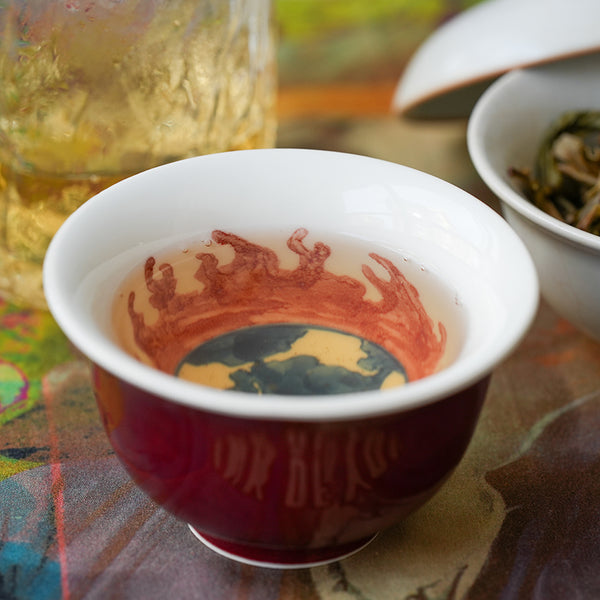 A cup or raw Puer tea with a golden yellow hue