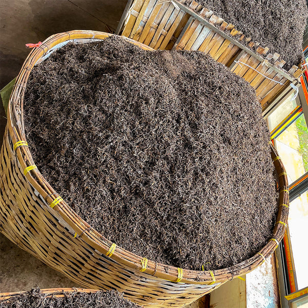 small batches of shou Puer tea in bamboo baskets