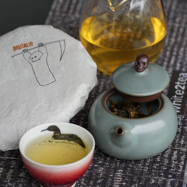 Brewed sheng Puerh tea with a teapot and teacup