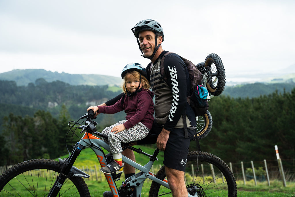 How to carry a balance bike on a backpack