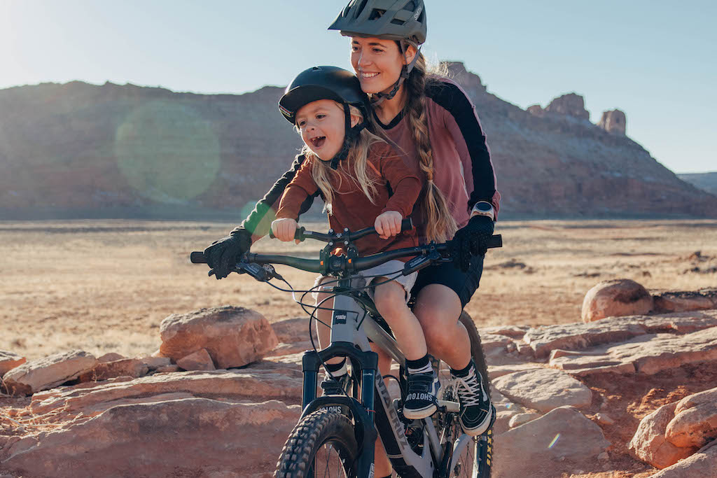 Mother and son mountain biking together