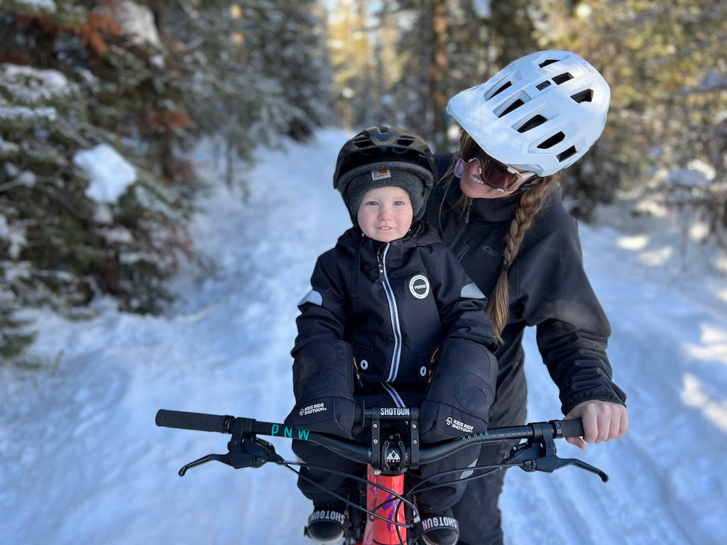 mum and son fat biking in the snow together
