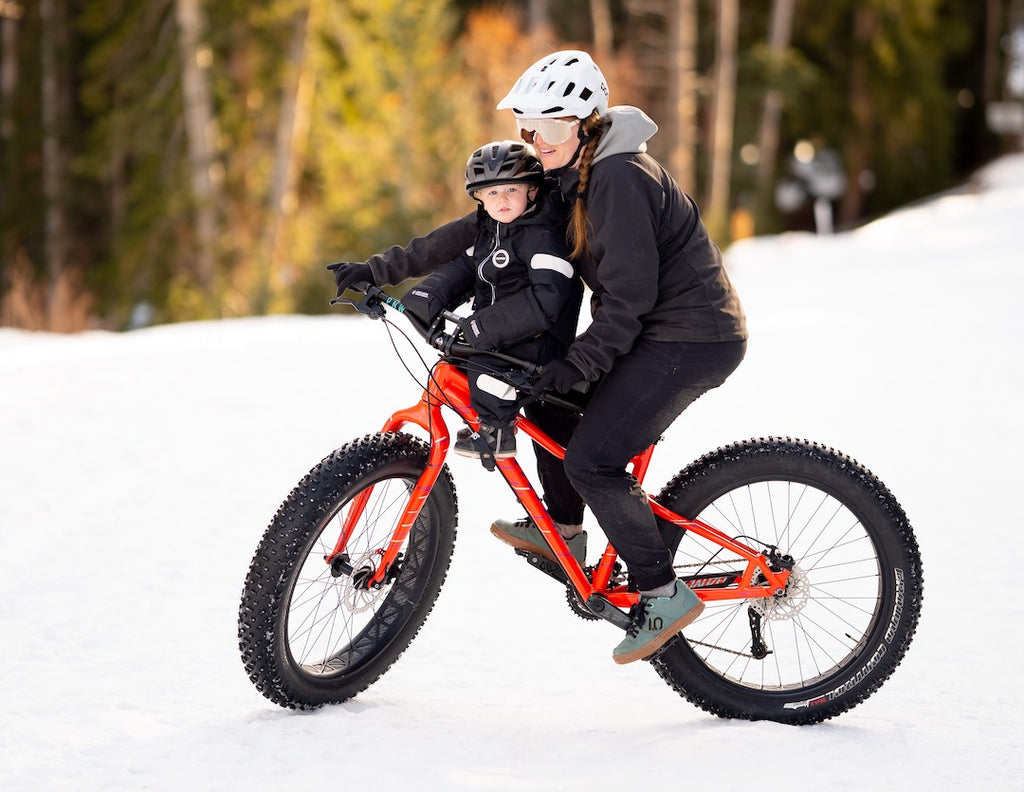 mum and son fat biking through the snow together