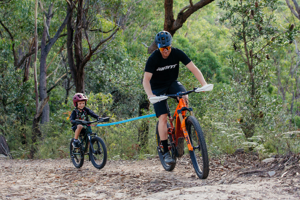 pro rider Josh Carlson towing son on the trails