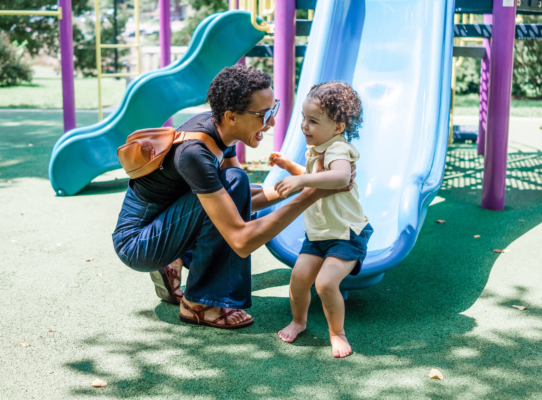 mom wearing minimalist diaper bag at playground