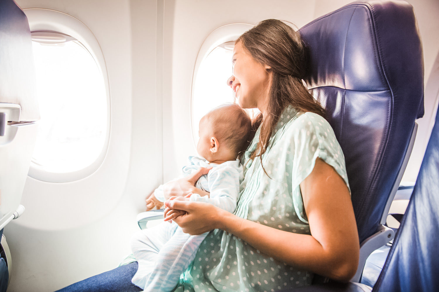 Mom with baby traveling on plane