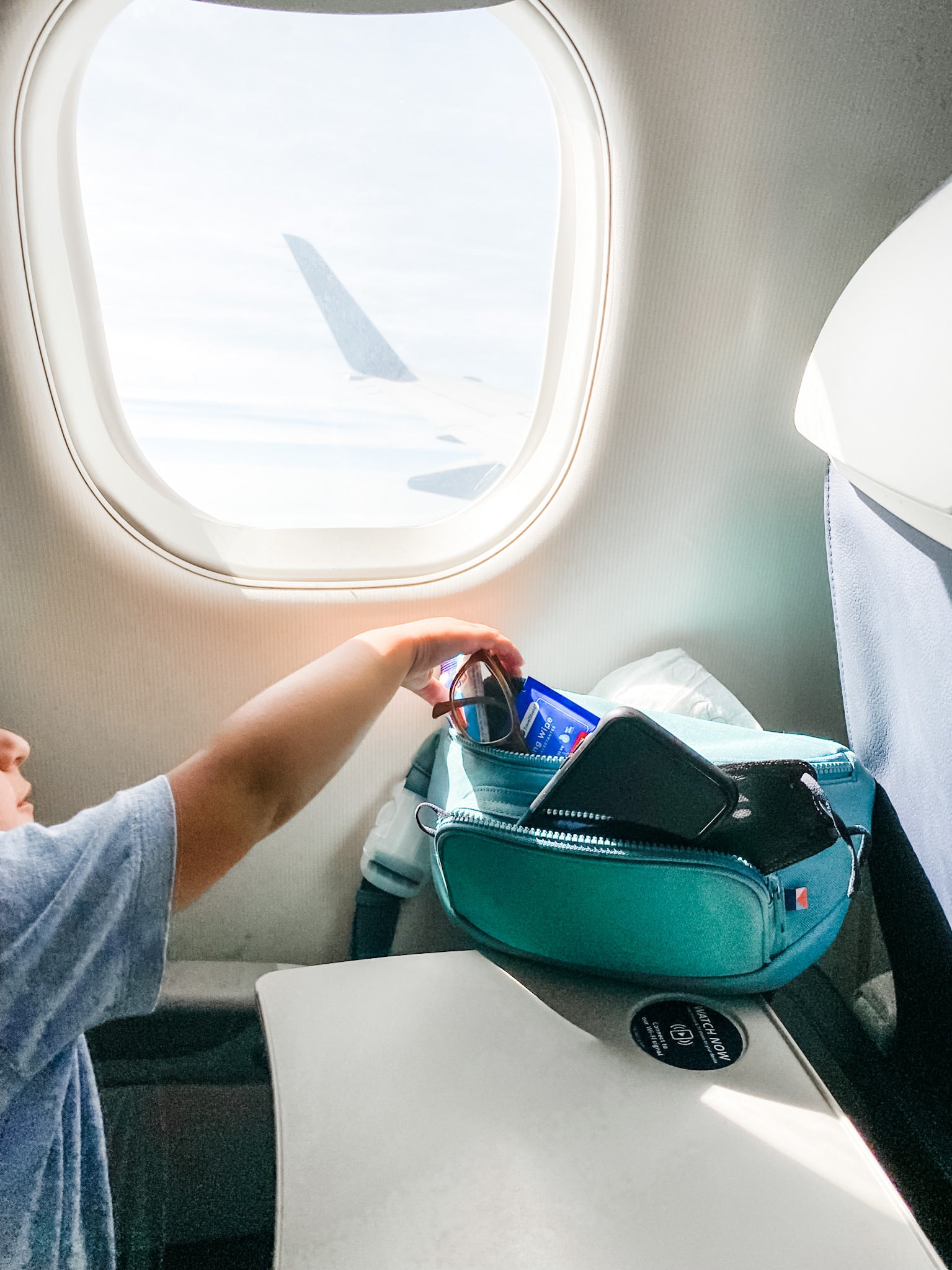 little boy reaching into kibou on plane