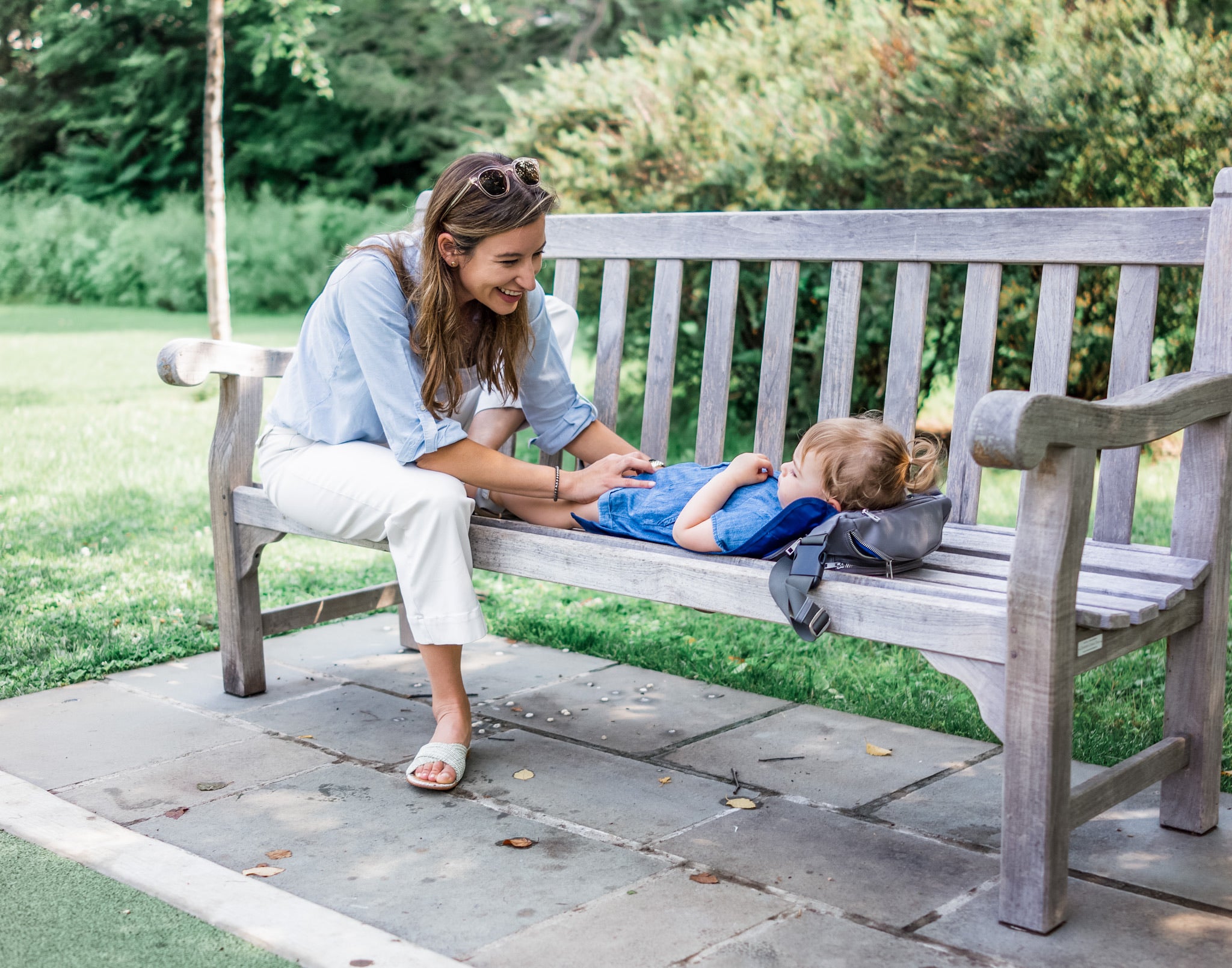 mom using on-the-go changing pad in minimalist diaper bag at the park