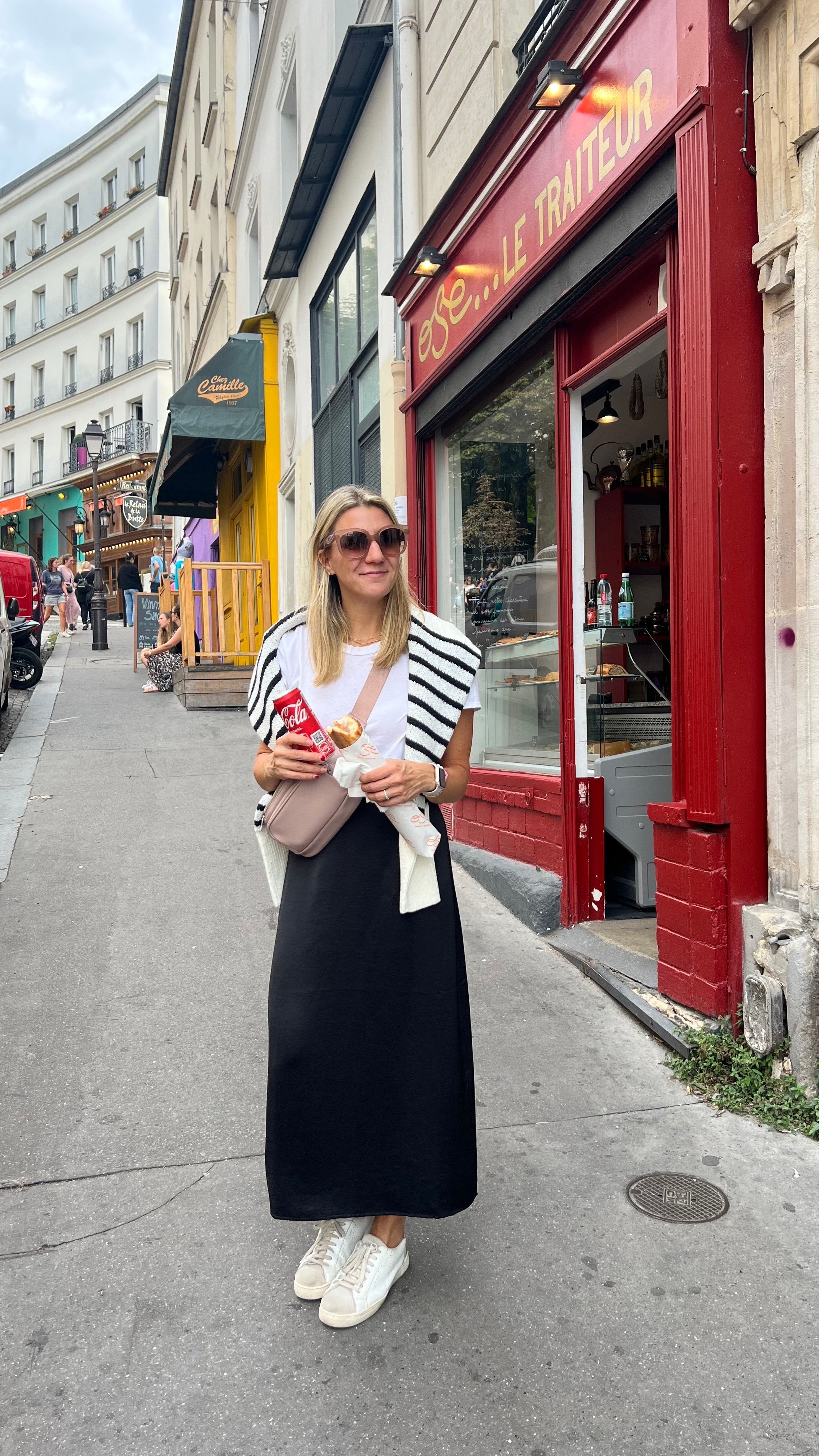 Woman wearing travel fanny pack while in Paris