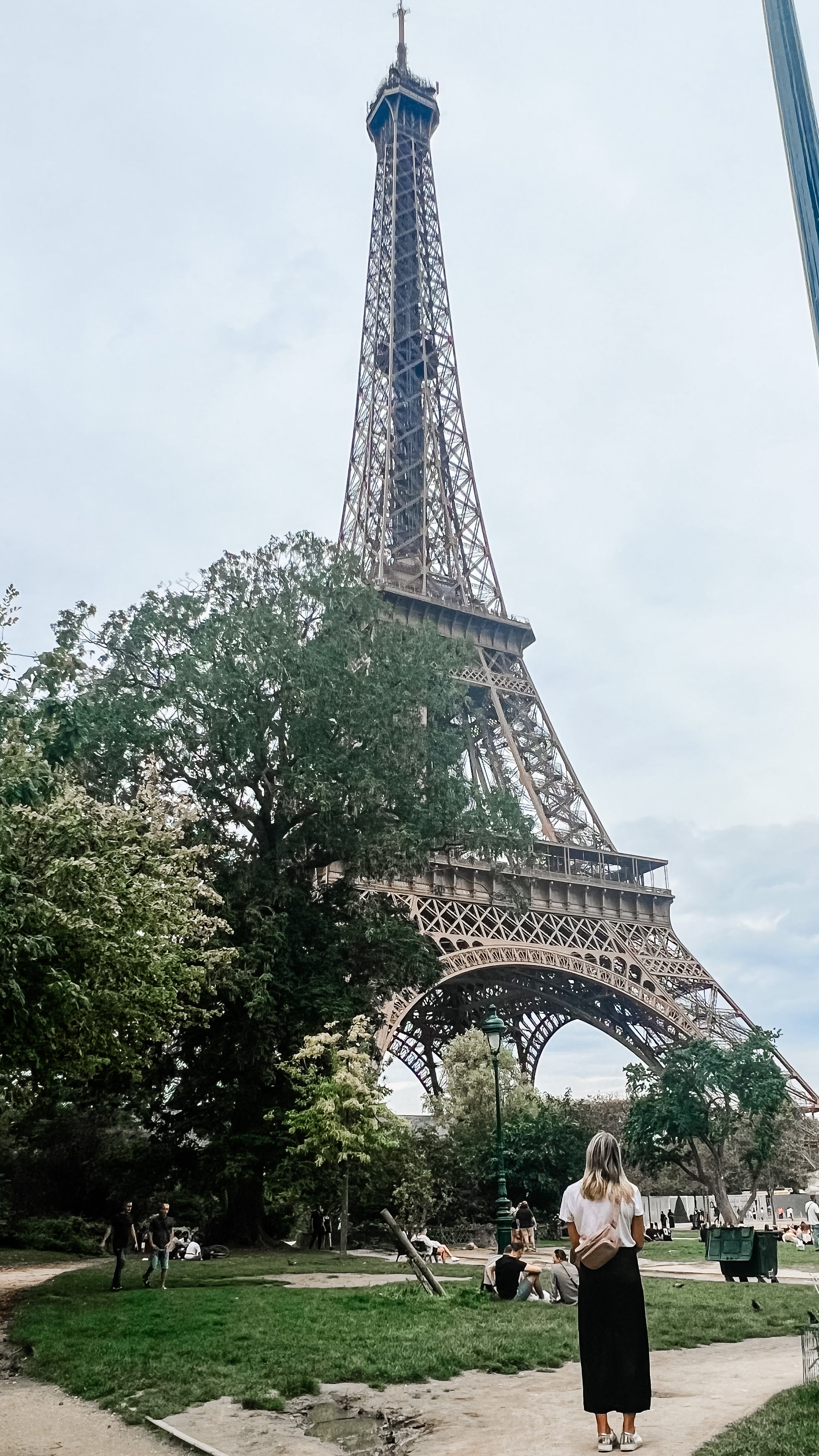 Woman wearing travel fanny pack looking at Eiffel Tower