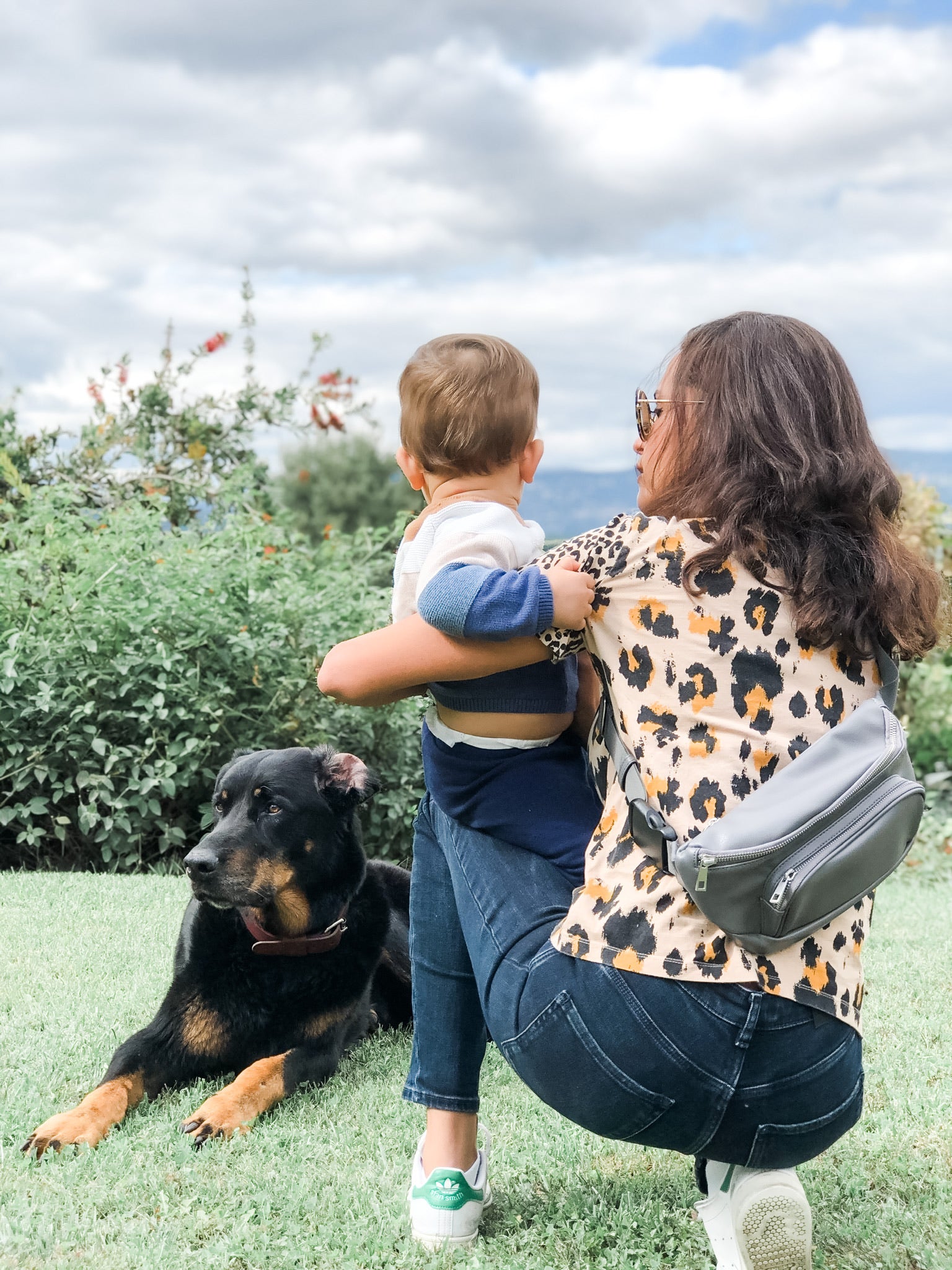 Mom and little boy with dog wearing a Kibou diaper bag in charcoal