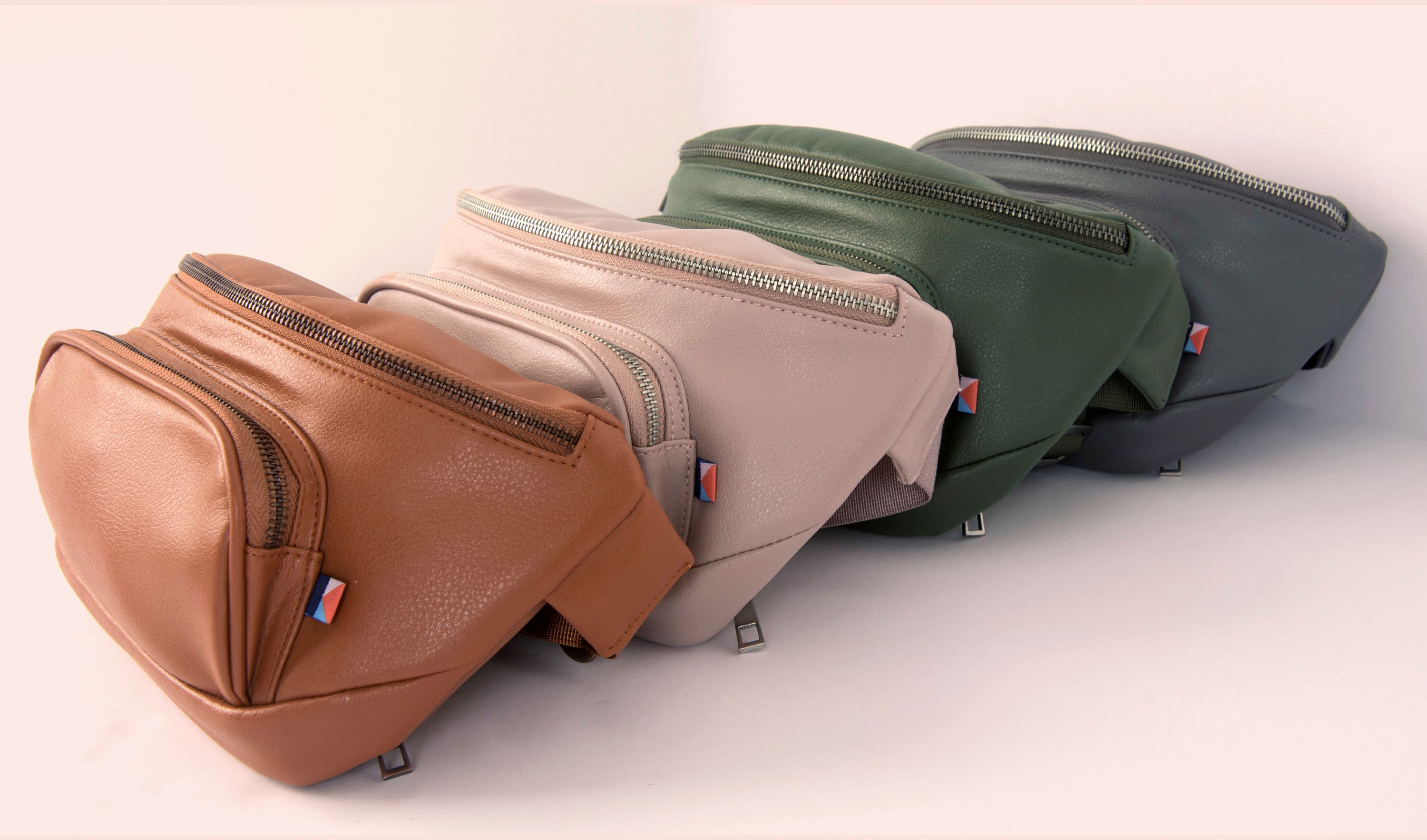 Kibou travel purses in vegan leather tan, blush, olive, and charcoal