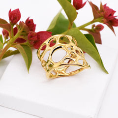 image of gold wide band cactus ring on white with flower