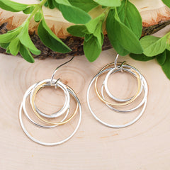 cluster circle earrings on wood background