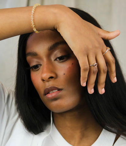 A model wearing Samayla Jewellery's 4mm Citrine bracelet and minimal Citrine gemstone rings