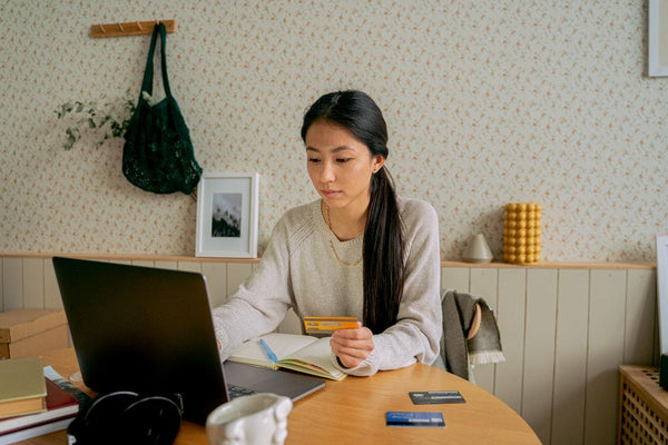 a woman purchasing CBD online using her credit card