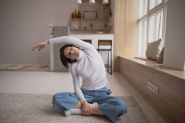A woman stretching on her bedroom floor