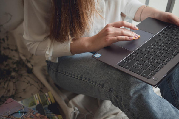 A woman typing on her laptop