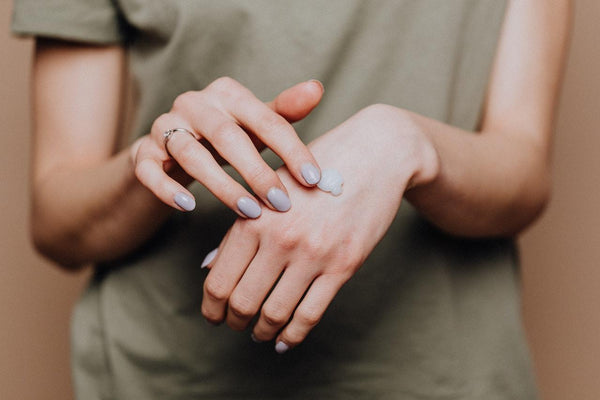 A woman applying cbd icy hot on her palm