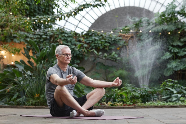 An older man laying down on a yoga mat