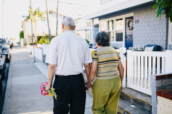A happy elderly couple walking on a sidewalk
