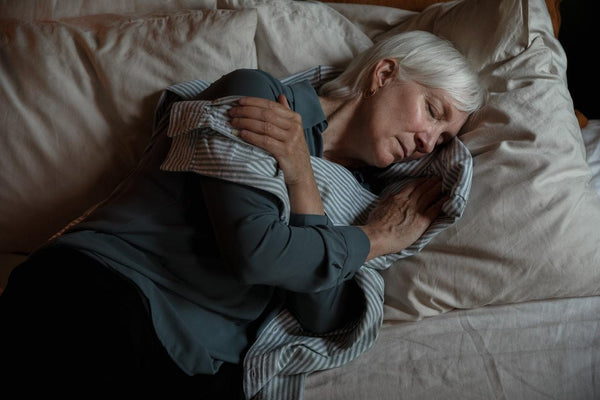 a woman in a stripped shirt laying down comfortably 