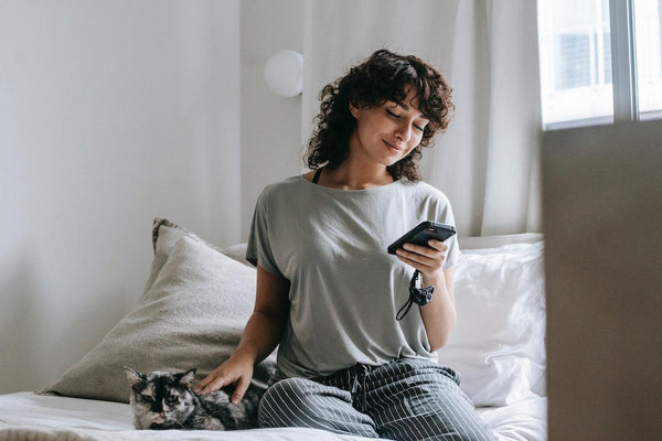 A woman checking her phone in bed