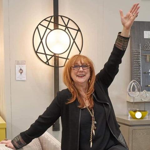 Robin Baron posing in front of one of her lighting designs
