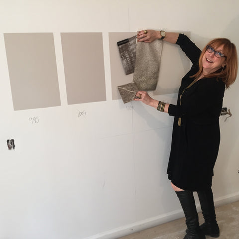 Robin Baron matches a fabric swatch to a wall paint color sample