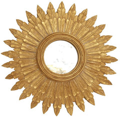 The Blomma Mirror, a golden mirror with an ornate border surrounding a small mirror.