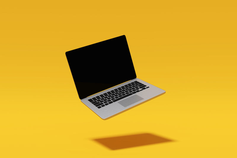 laptop on yellow background