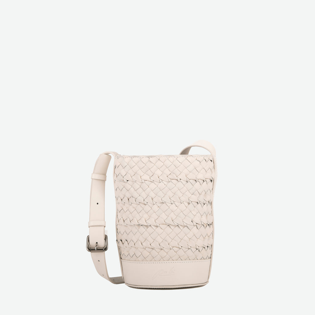 A mini small stone white woven leather bucket bag  with an adjustable crossbody strap - image 1