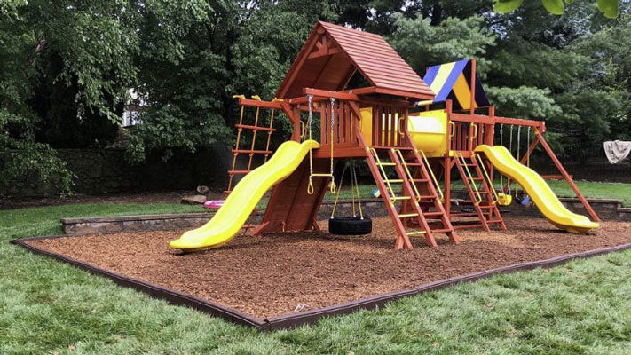 Playground with rubber mulch and rubber timber playground border edging