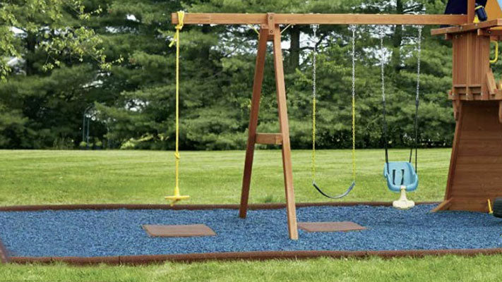 Rubberific playground swing mats on top of blue rubber mulch
