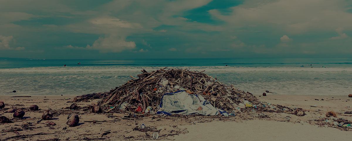 pile of trash next to the ocean