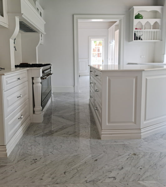 traditional style kitchen with marble floor and white cubpboards