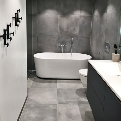 bathroom with grey cement wall and floor
